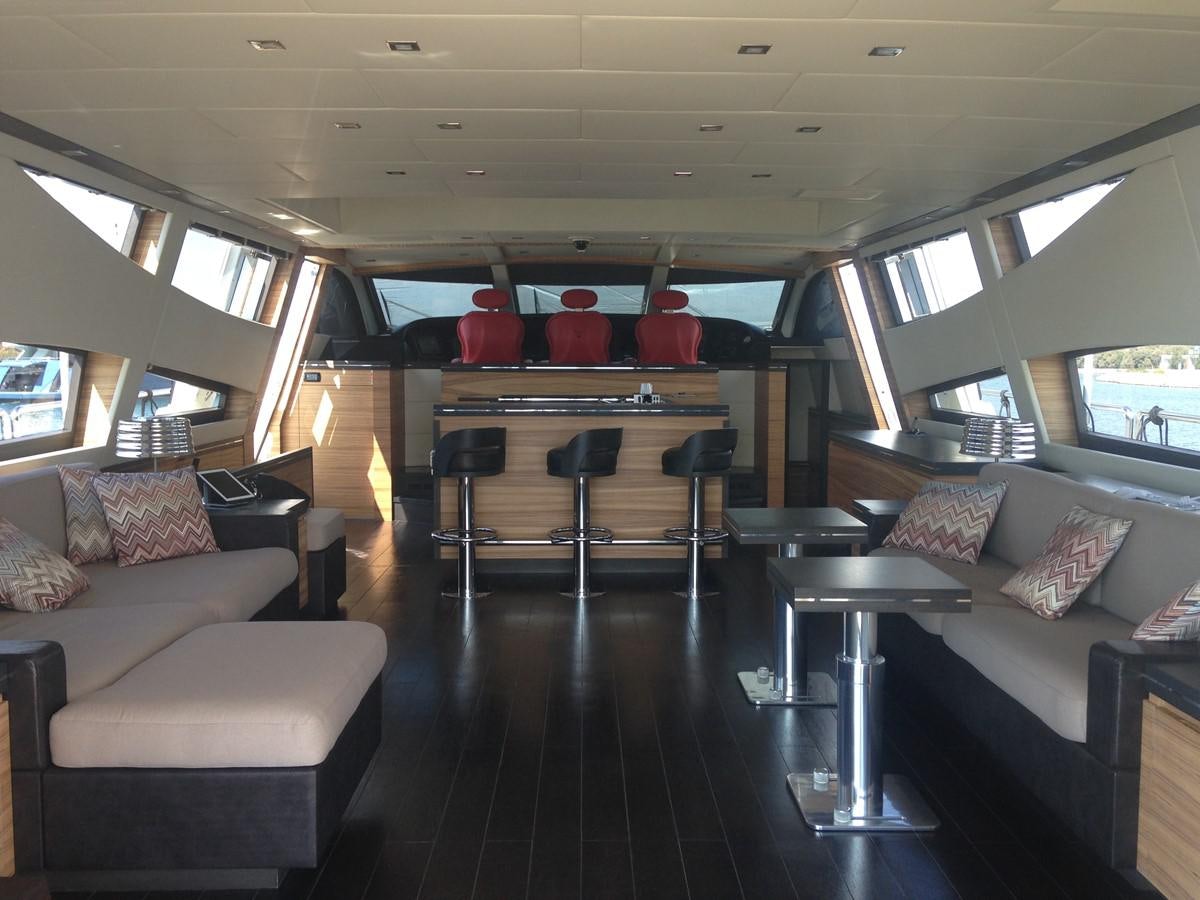 a living room with a wood table and couches aboard LEOPARD Yacht for Sale