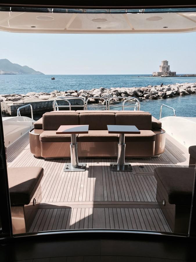 a group of lounge chairs on a deck overlooking a body of water aboard LEOPARD Yacht for Sale