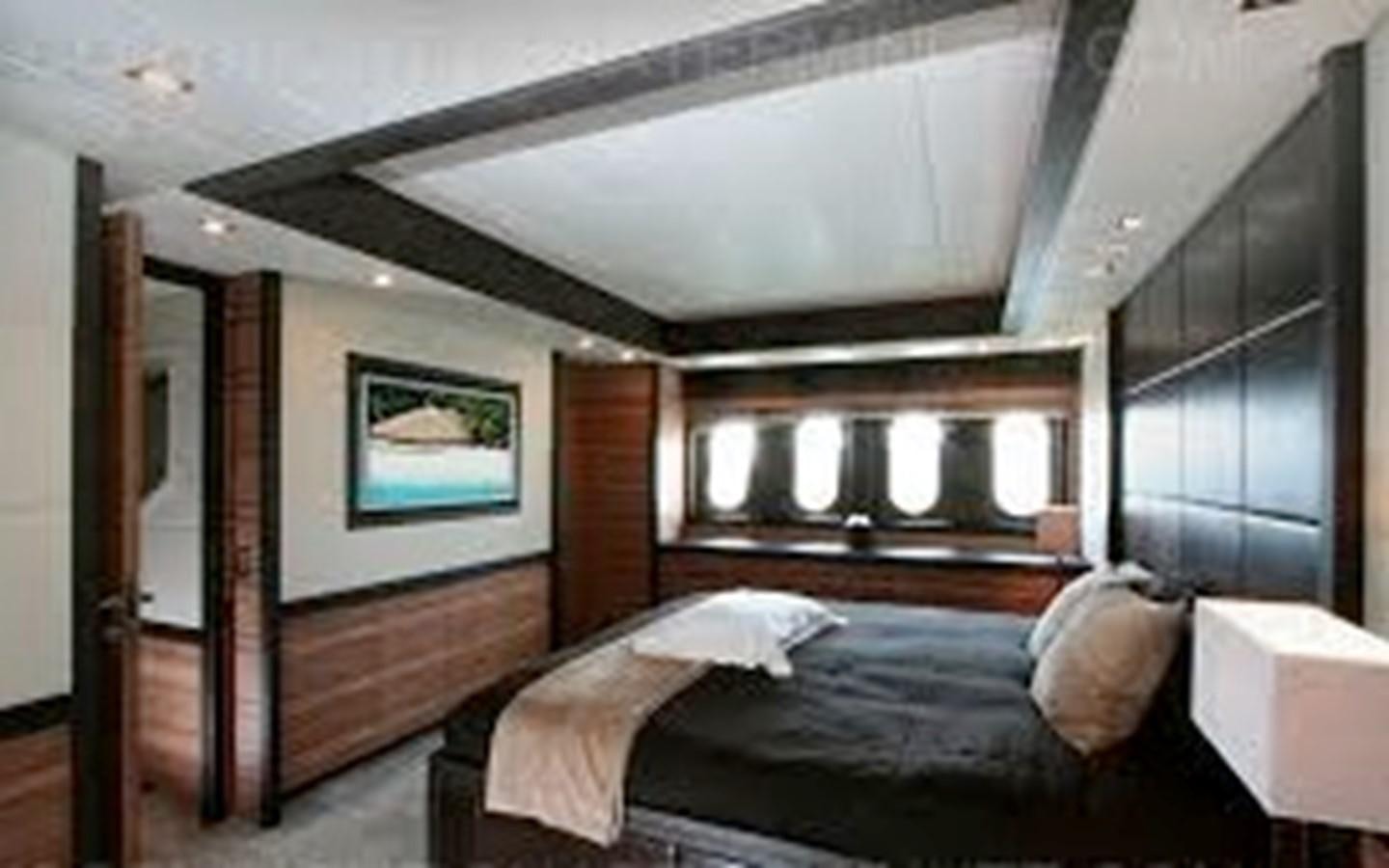 a bedroom with a bed and a mirror aboard LEOPARD Yacht for Sale