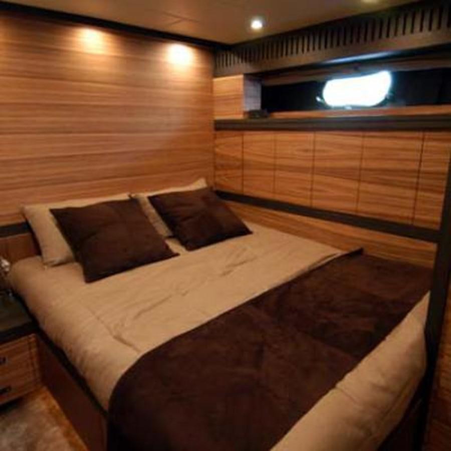 a bed with a wooden headboard aboard LEOPARD Yacht for Sale