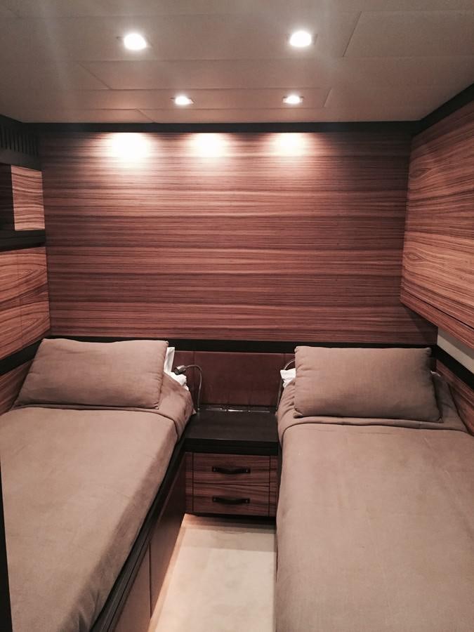 a room with a bed and a dresser aboard LEOPARD Yacht for Sale