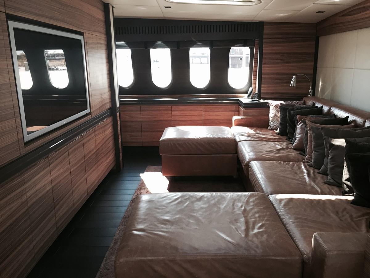 a living room with leather couches aboard LEOPARD Yacht for Sale