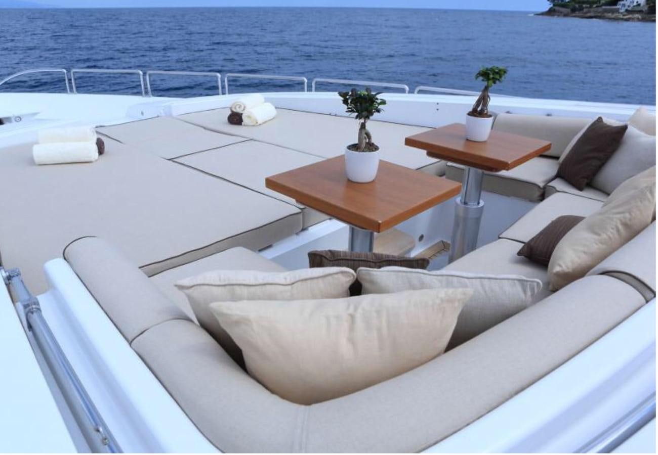 a white couch with a table on it next to a plant on a table aboard LEOPARD Yacht for Sale