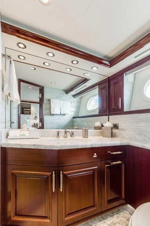 a bathroom with a large mirror aboard OUR HERITAGE Yacht for Sale