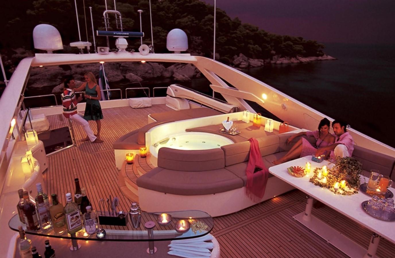 a group of people sitting around a table with food on it aboard FERRETTI CUSTOM LINE 112 Yacht for Sale
