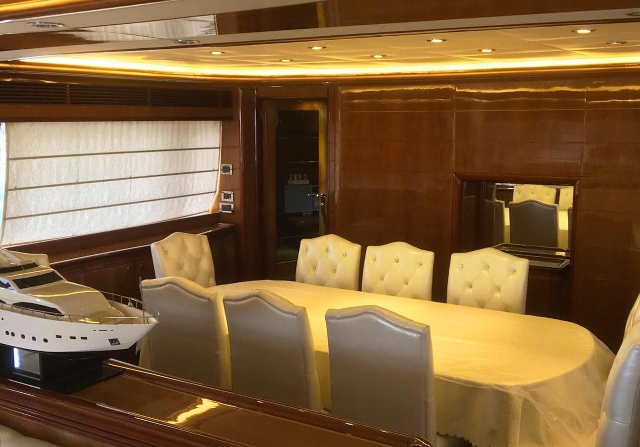 a room with a table and chairs aboard FERRETTI CUSTOM LINE 112 Yacht for Sale