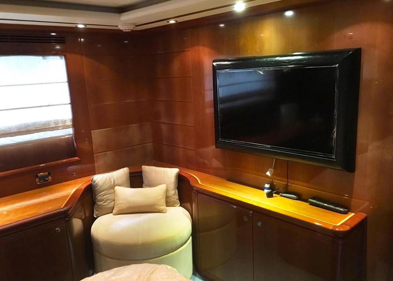 a room with a tv and a chair aboard FERRETTI CUSTOM LINE 112 Yacht for Sale