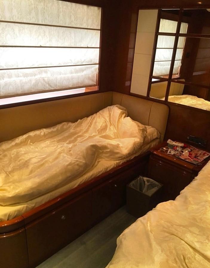 a bed with a window aboard FERRETTI CUSTOM LINE 112 Yacht for Sale