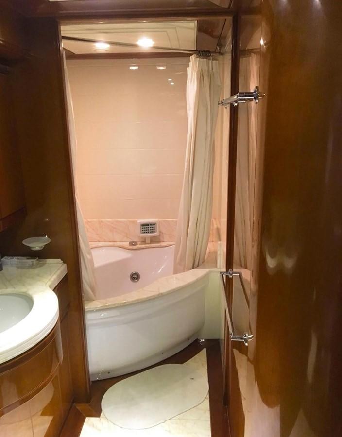 a bathroom with a tub sink and toilet aboard FERRETTI CUSTOM LINE 112 Yacht for Sale