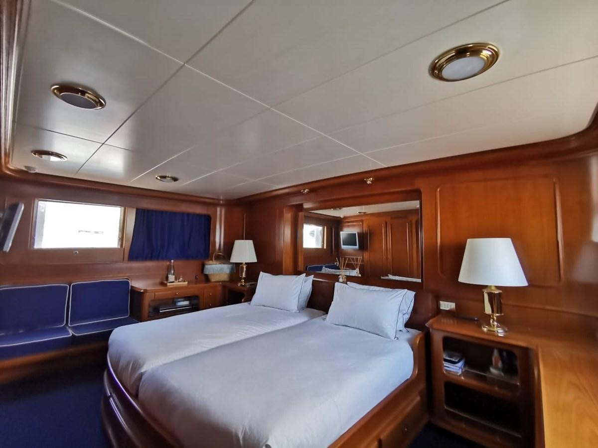 a room with a bed and a desk aboard BEL AMI II Yacht for Sale