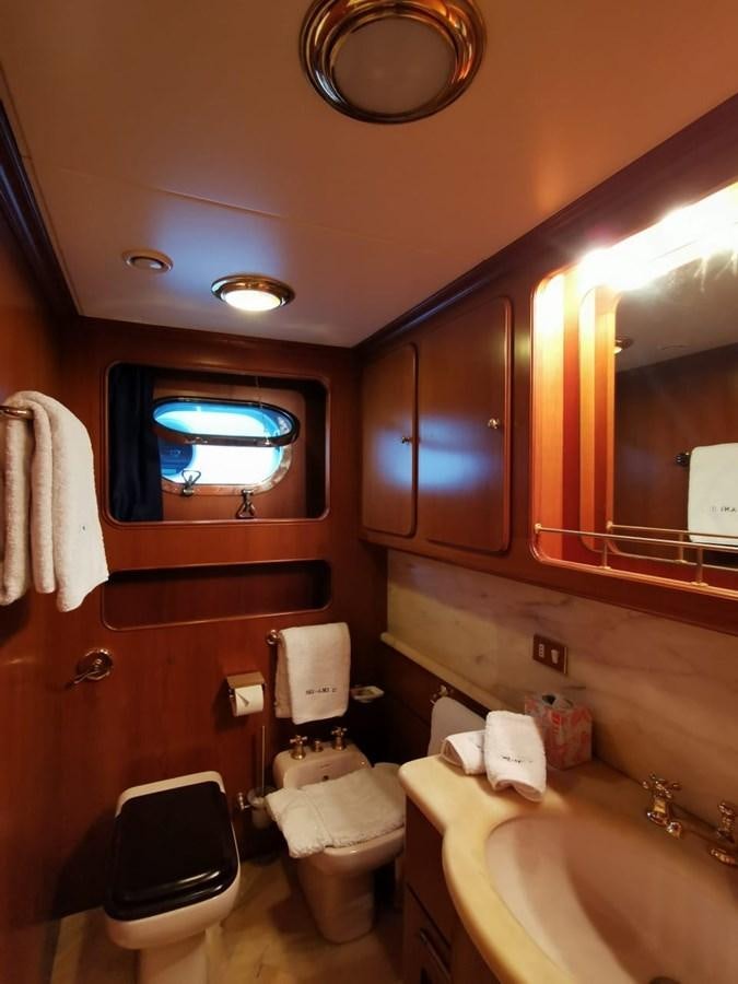 a bathroom with a toilet and a sink aboard BEL AMI II Yacht for Sale
