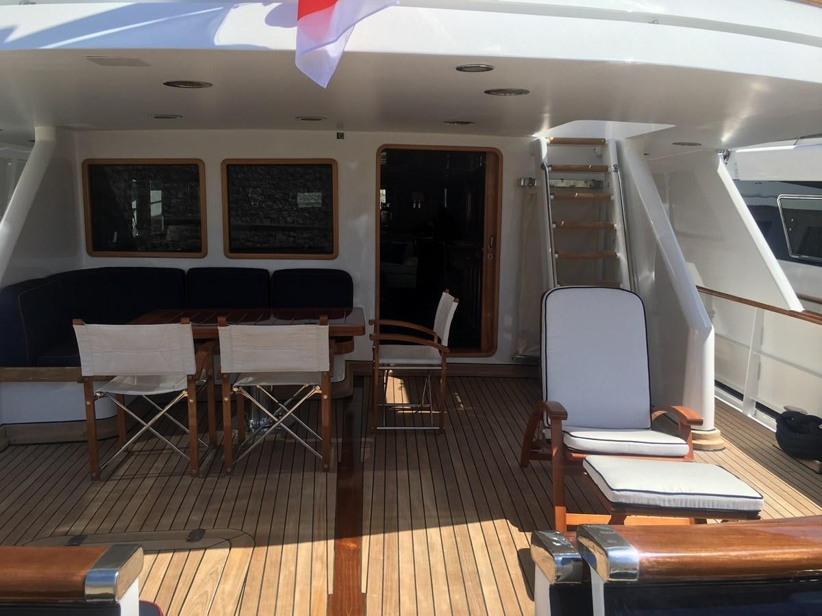 a room with a table and chairs aboard BEL AMI II Yacht for Sale