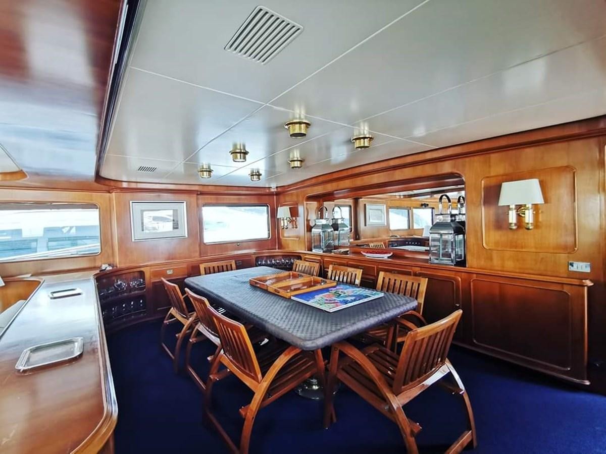 a dining room with a table aboard BEL AMI II Yacht for Sale