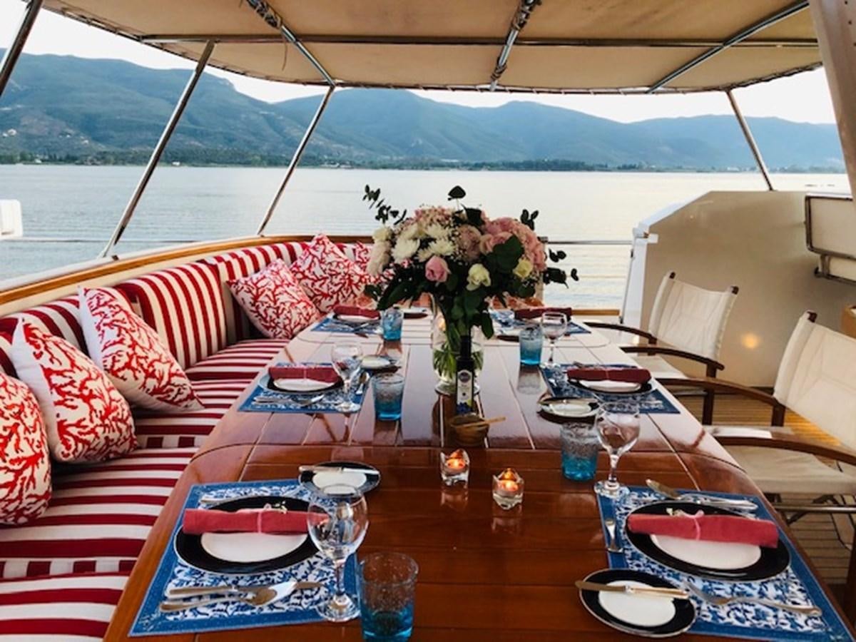 a table with plates and glasses aboard BEL AMI II Yacht for Sale