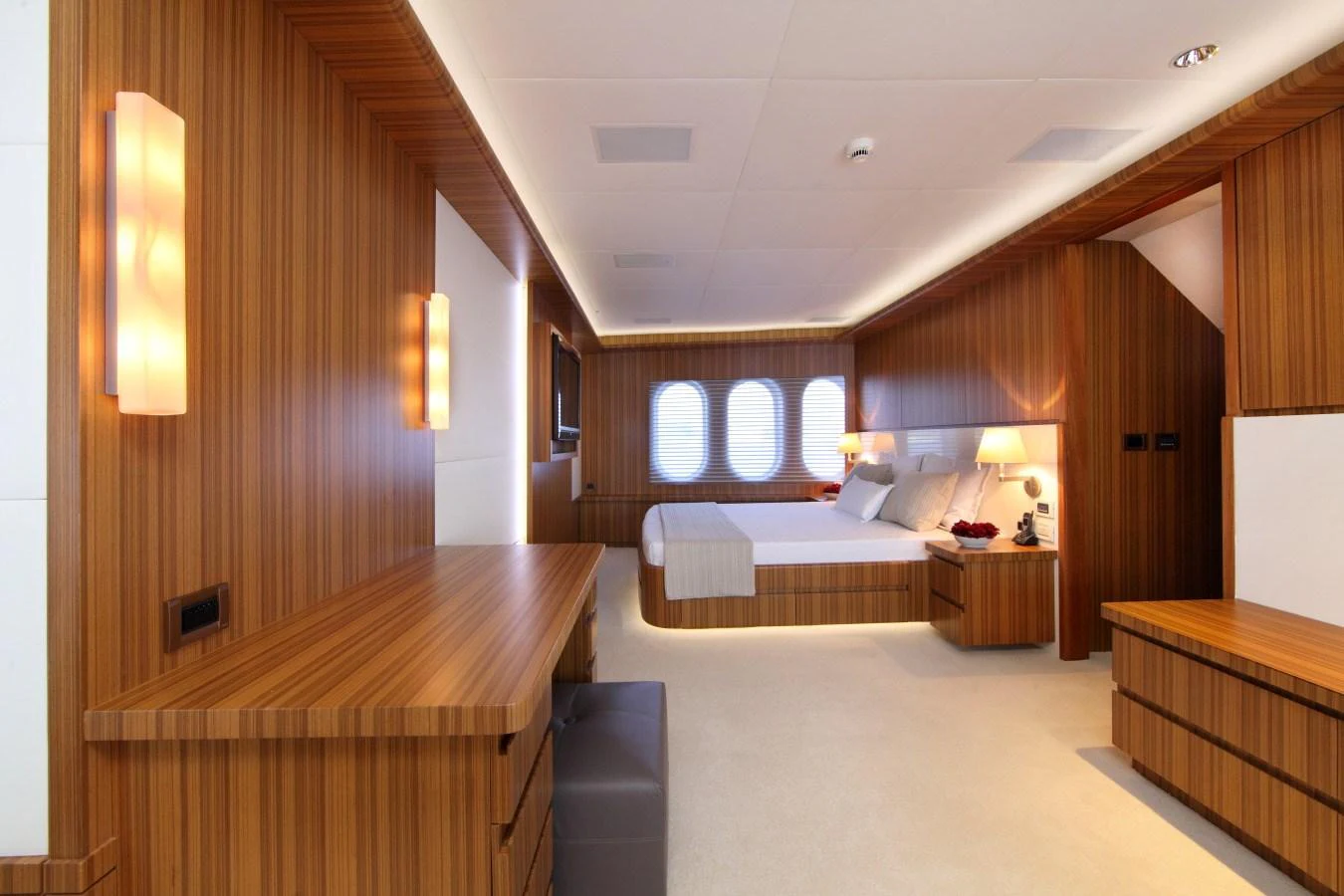 a hotel room with a bed and desk aboard SEA SHELL Yacht for Charter