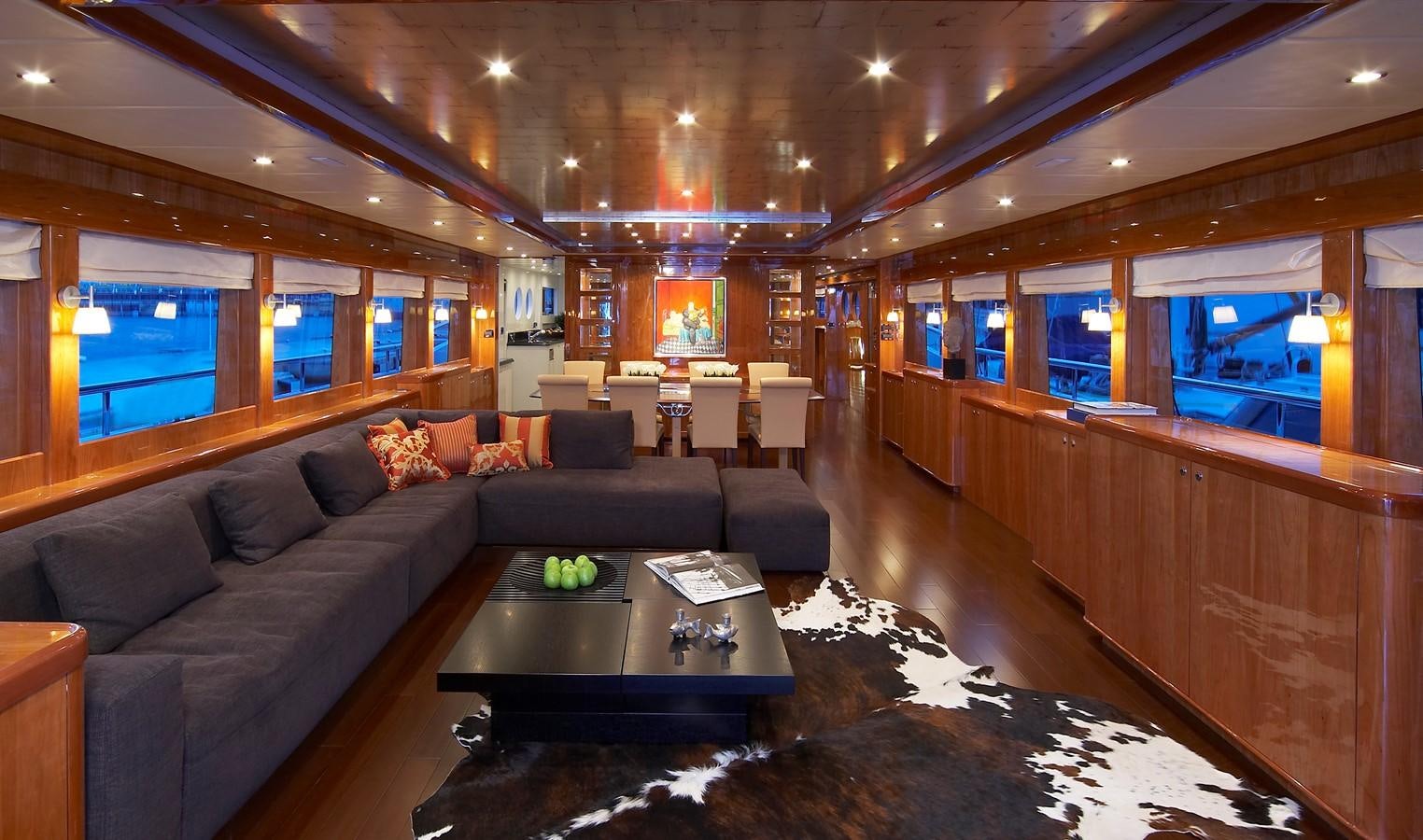 a living room with a couch and a coffee table aboard JOHNSON 110 FLYBRIDGE Yacht for Charter