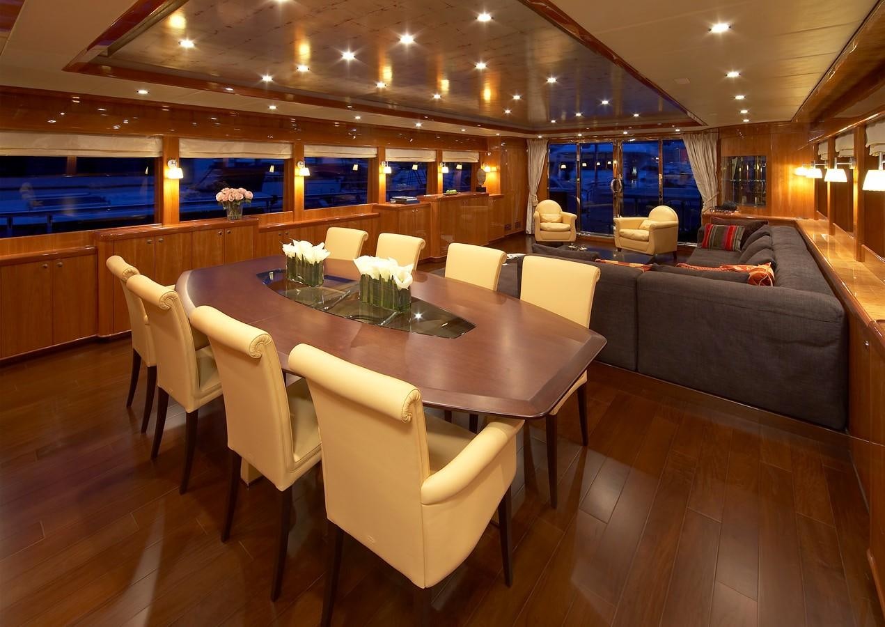 a room with a table and chairs aboard JOHNSON 110 FLYBRIDGE Yacht for Charter