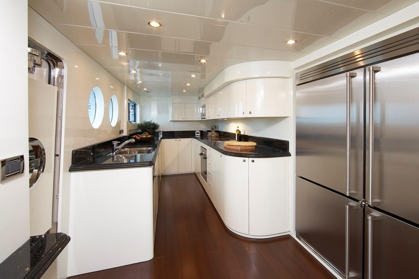 a kitchen with white cabinets aboard JOHNSON 110 FLYBRIDGE Yacht for Charter