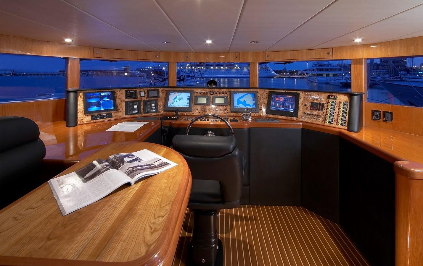 a room with a desk and chairs aboard JOHNSON 110 FLYBRIDGE Yacht for Charter