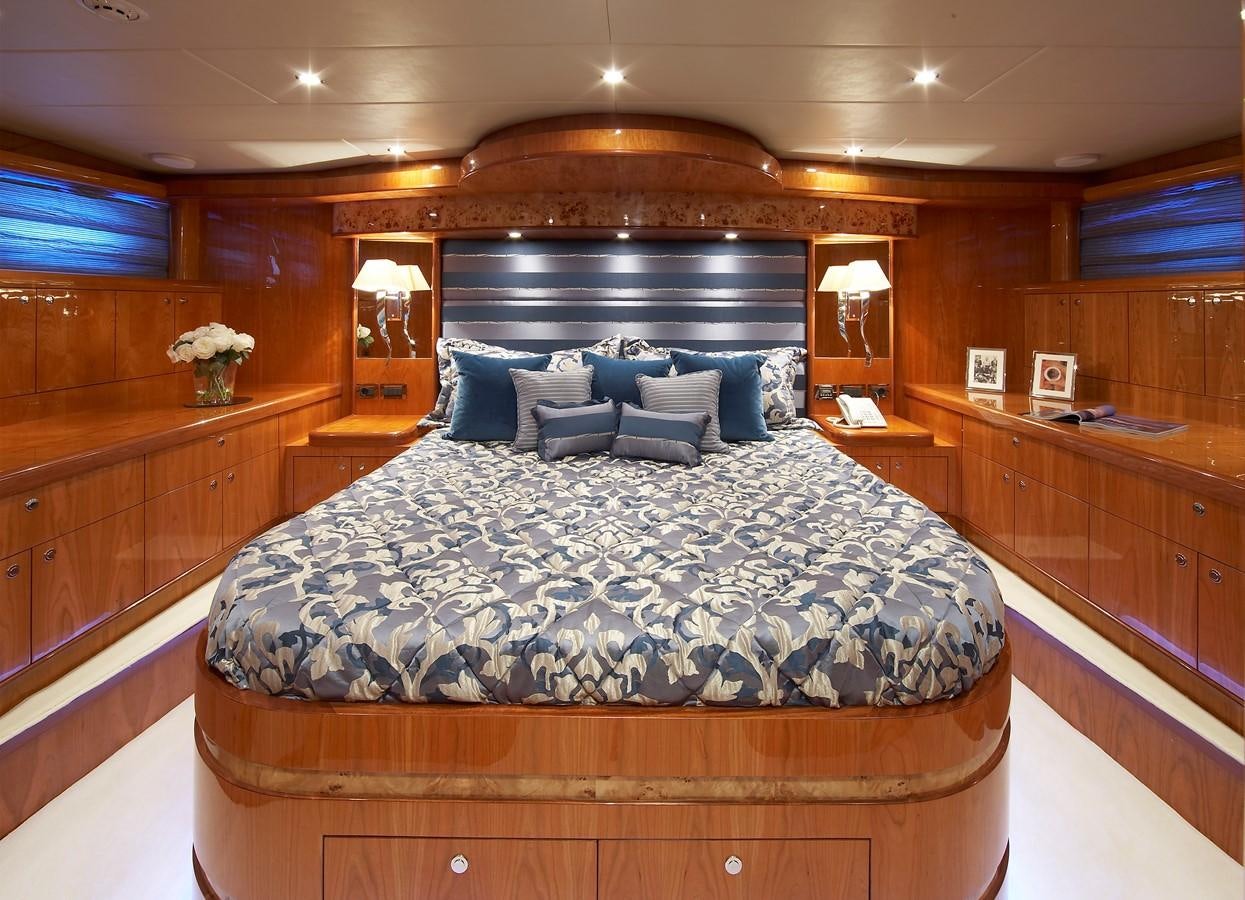 a large bed in a room aboard JOHNSON 110 FLYBRIDGE Yacht for Charter