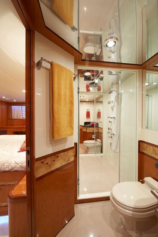 a bathroom with a shower and toilet aboard JOHNSON 110 FLYBRIDGE Yacht for Charter