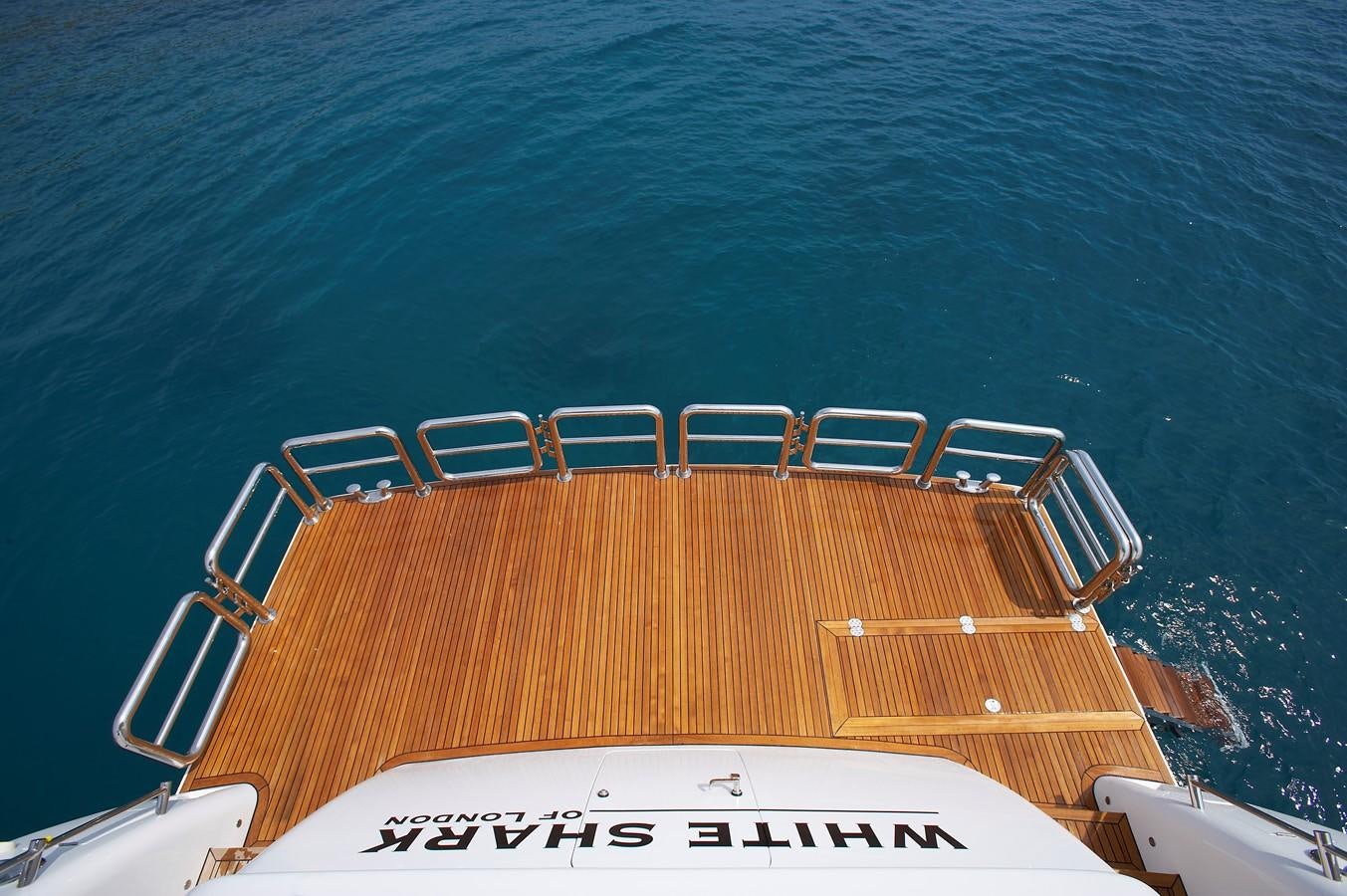a large orange and white boat on the water aboard JOHNSON 110 FLYBRIDGE Yacht for Charter