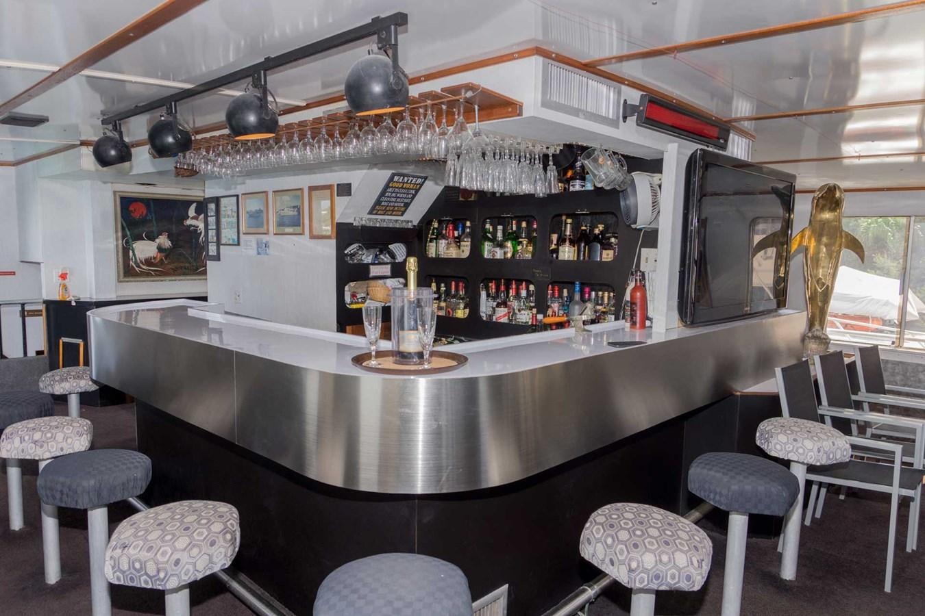 a bar with a bar and stools aboard LADY TAMARA Yacht for Sale