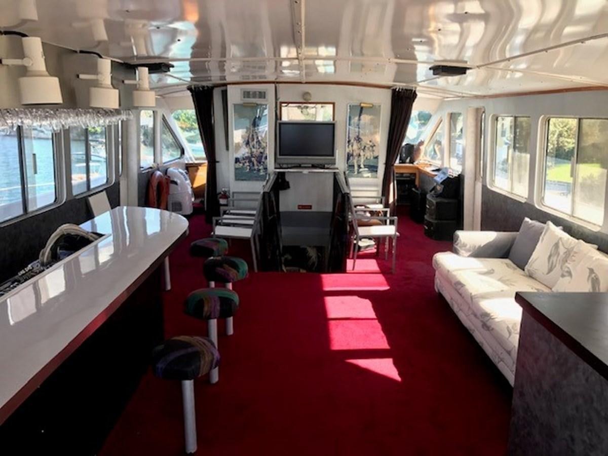 a living room with a red rug aboard LADY TAMARA Yacht for Sale