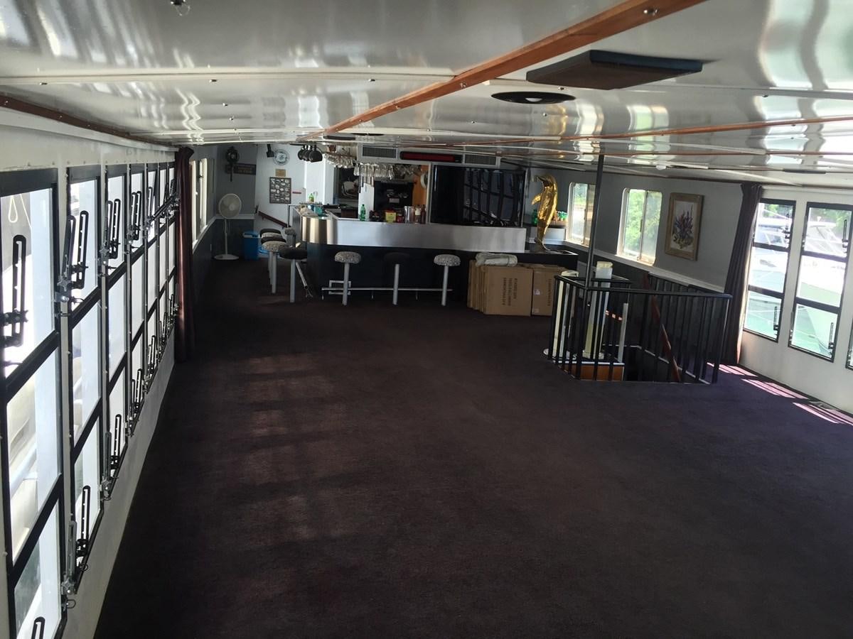 a room with tables and chairs aboard LADY TAMARA Yacht for Sale