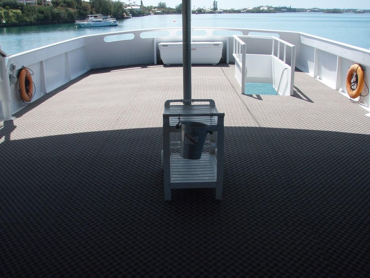 a table and chairs on a deck aboard LADY TAMARA Yacht for Sale
