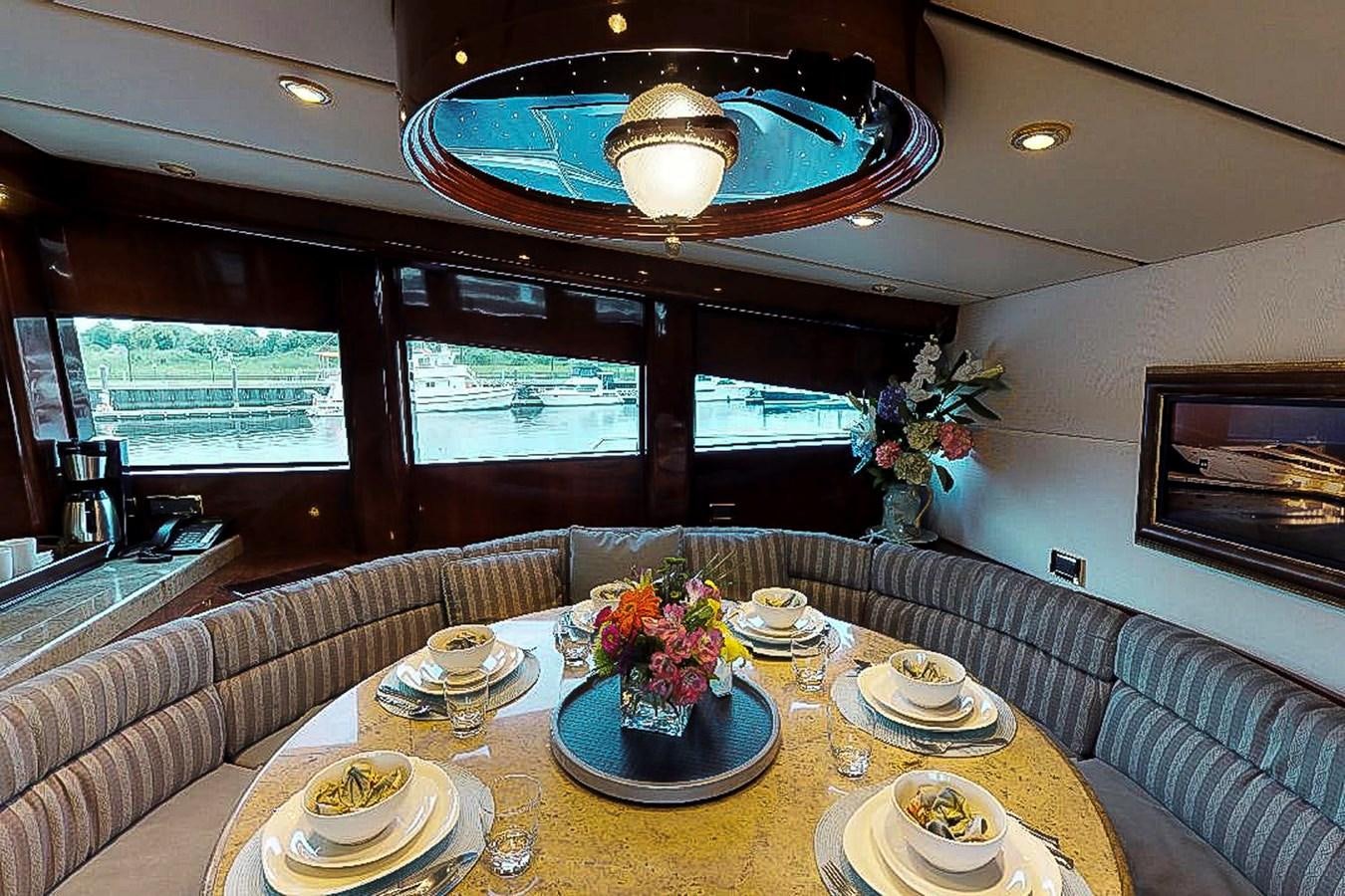 a dining room with a chandelier and plates aboard IDLETYME II Yacht for Sale