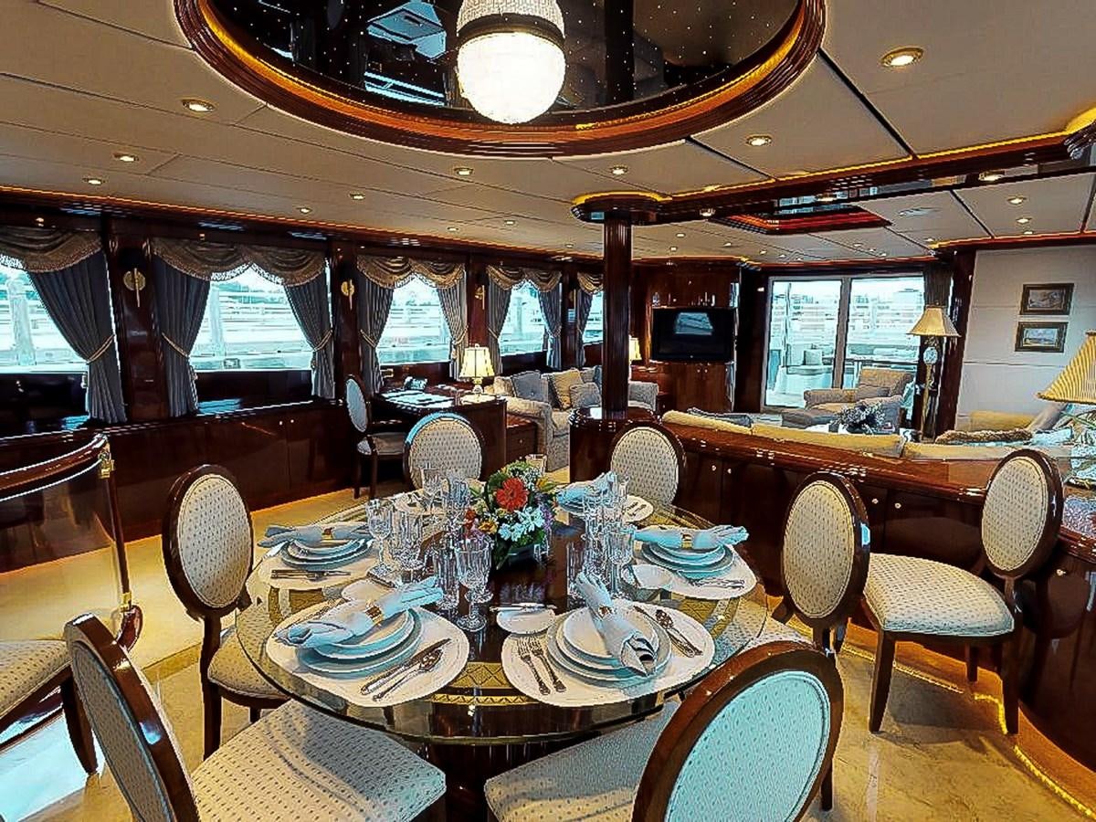 a dining room with a table set aboard IDLETYME II Yacht for Sale