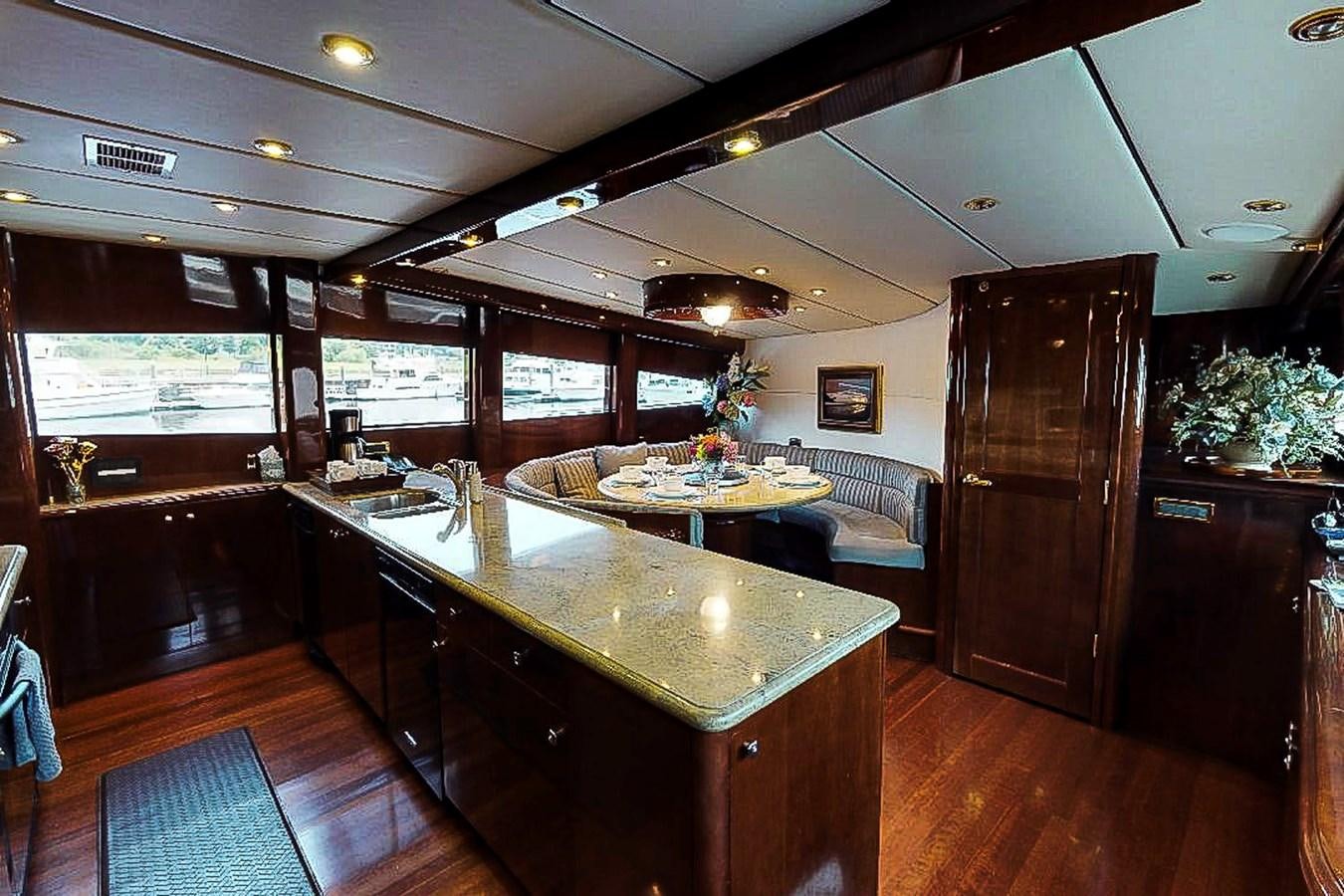 a large kitchen with a dining table aboard IDLETYME II Yacht for Sale