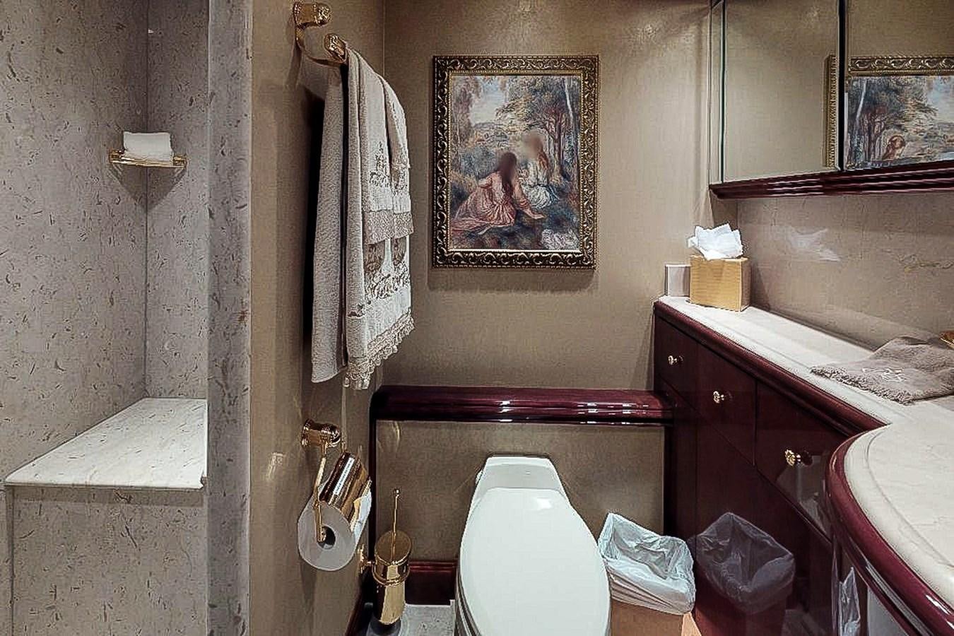 a bathroom with a painting on the wall aboard IDLETYME II Yacht for Sale