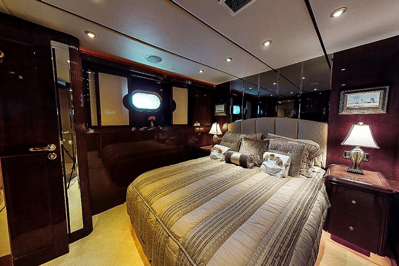 a bedroom with a bed and a television aboard IDLETYME II Yacht for Sale