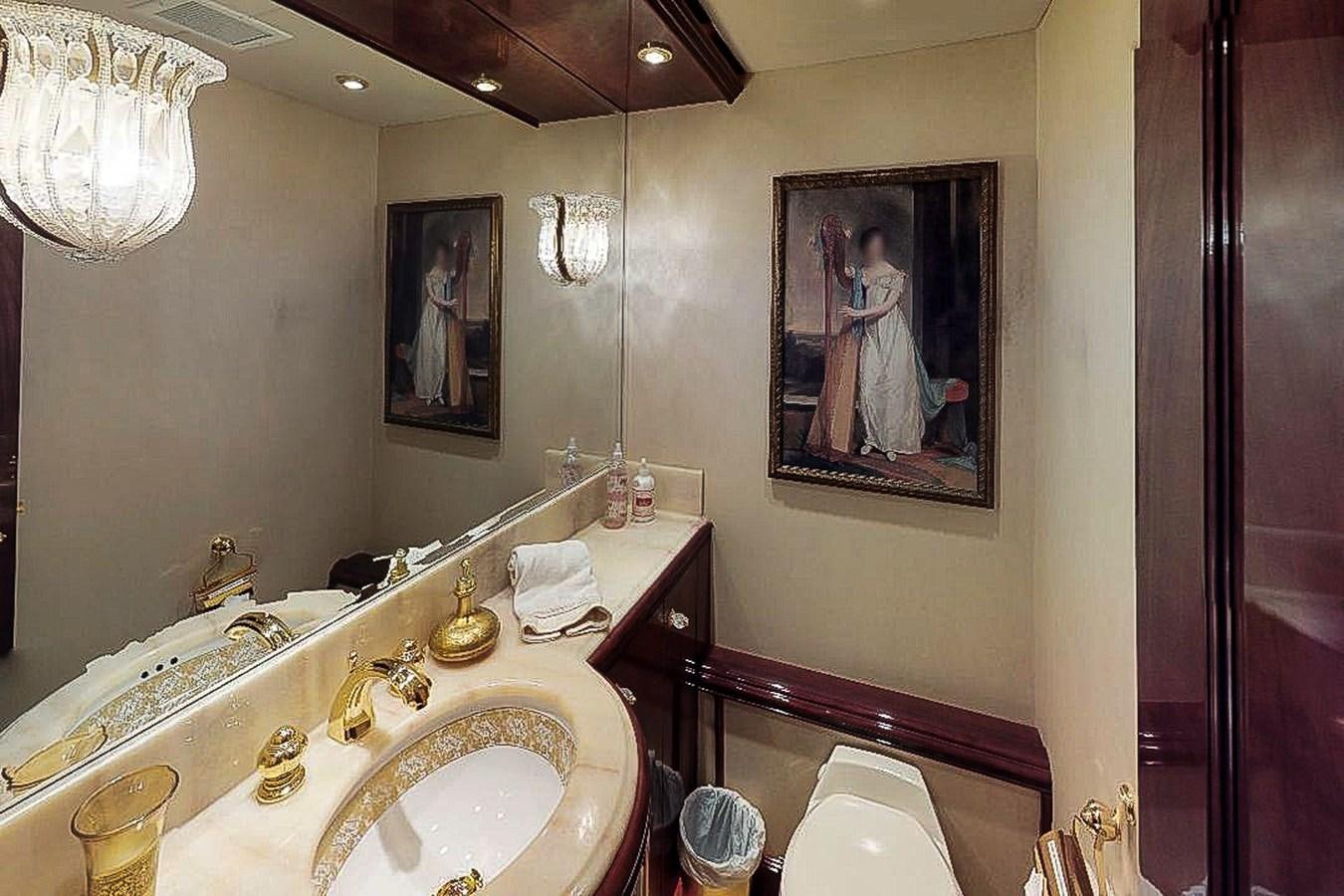 a bathroom with a painting on the wall aboard IDLETYME II Yacht for Sale