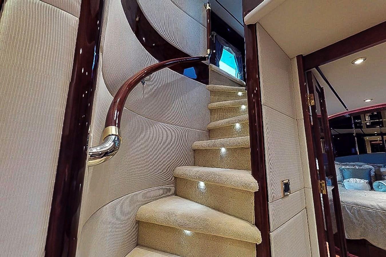 a staircase with a wood railing aboard IDLETYME II Yacht for Sale