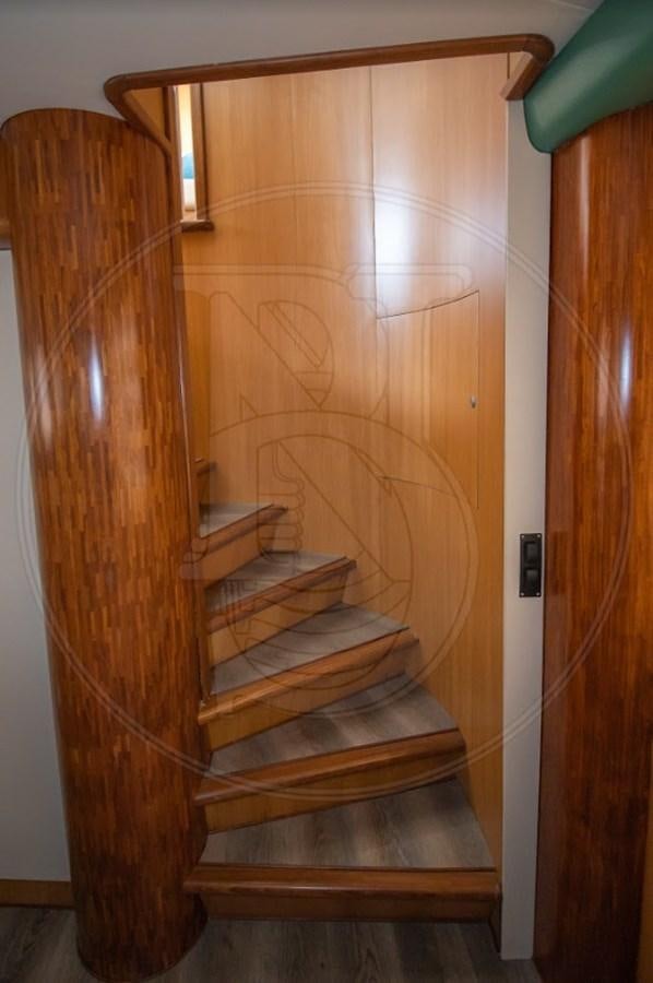 a wooden staircase with a wood frame aboard ANGELE Yacht for Sale