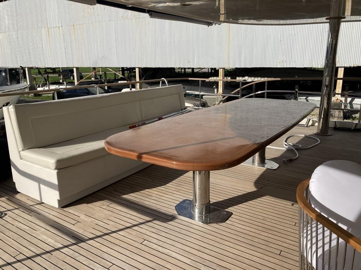 a large wooden table in a room aboard ANGELE Yacht for Sale
