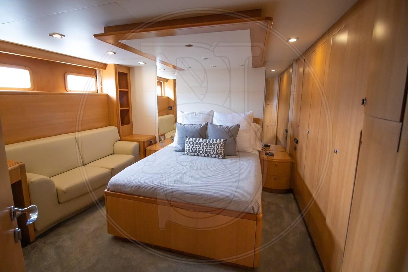 a bedroom with a bed and a couch aboard ANGELE Yacht for Sale
