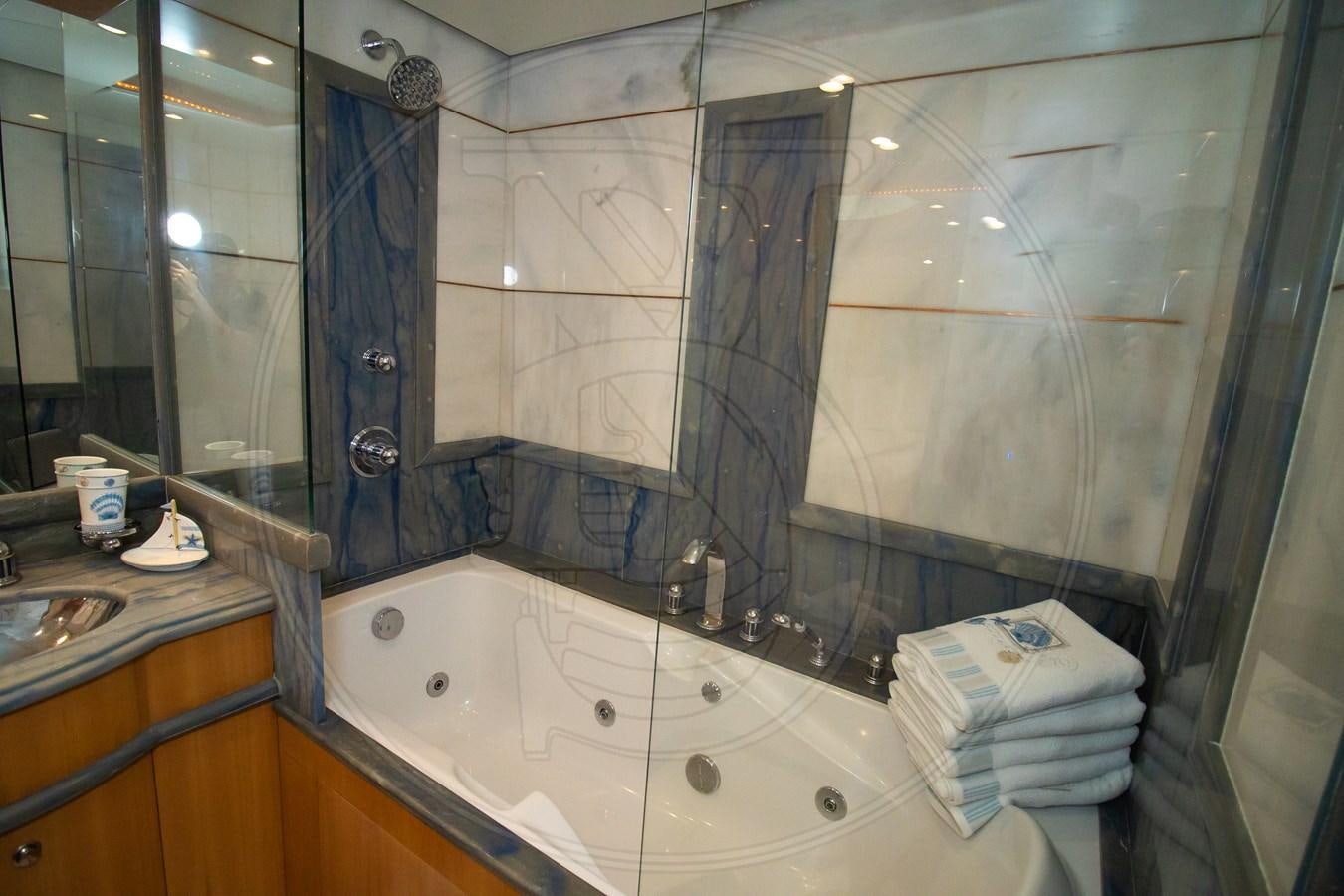 a bathroom with a large mirror aboard ANGELE Yacht for Sale