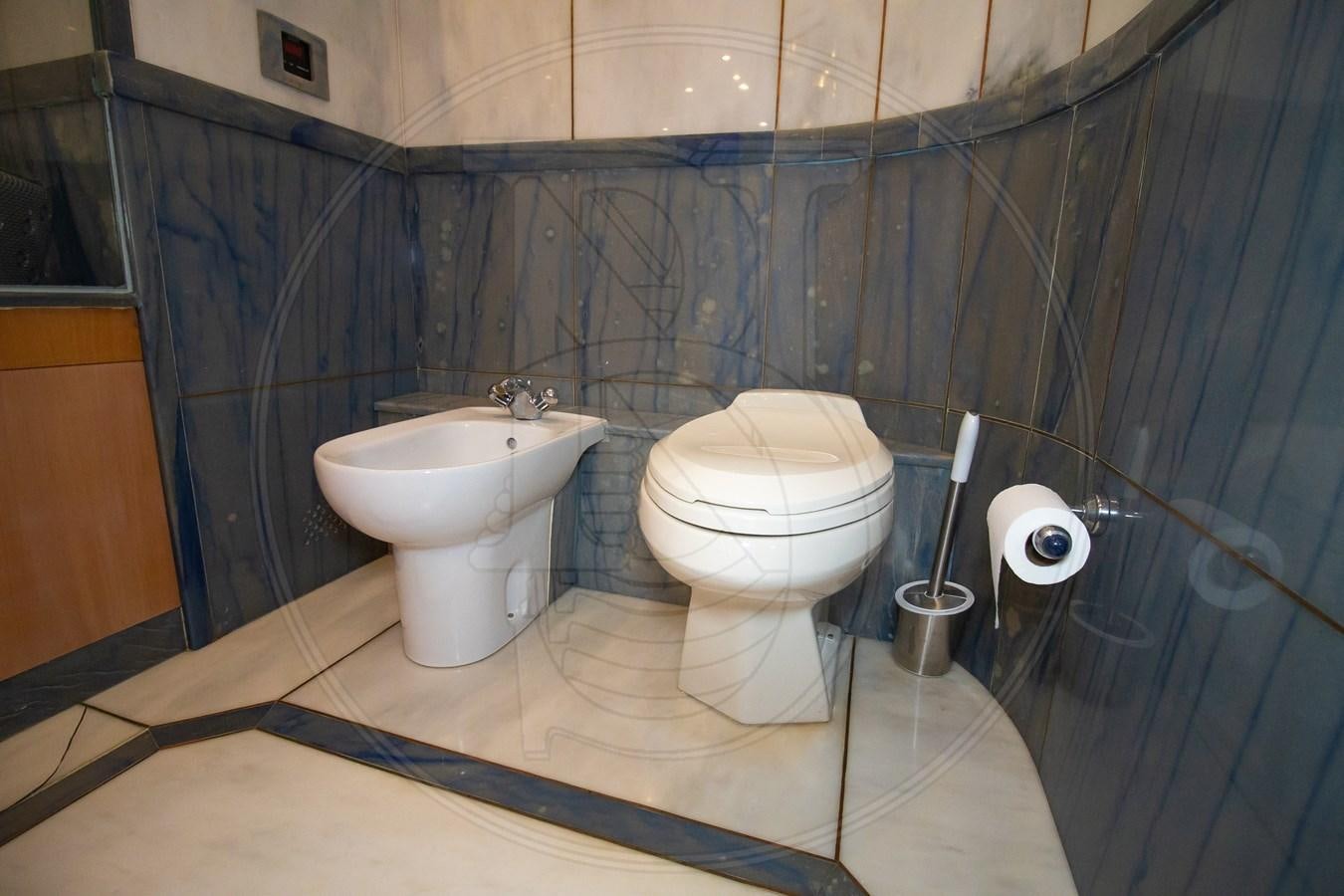 a bathroom with a toilet and sink aboard ANGELE Yacht for Sale
