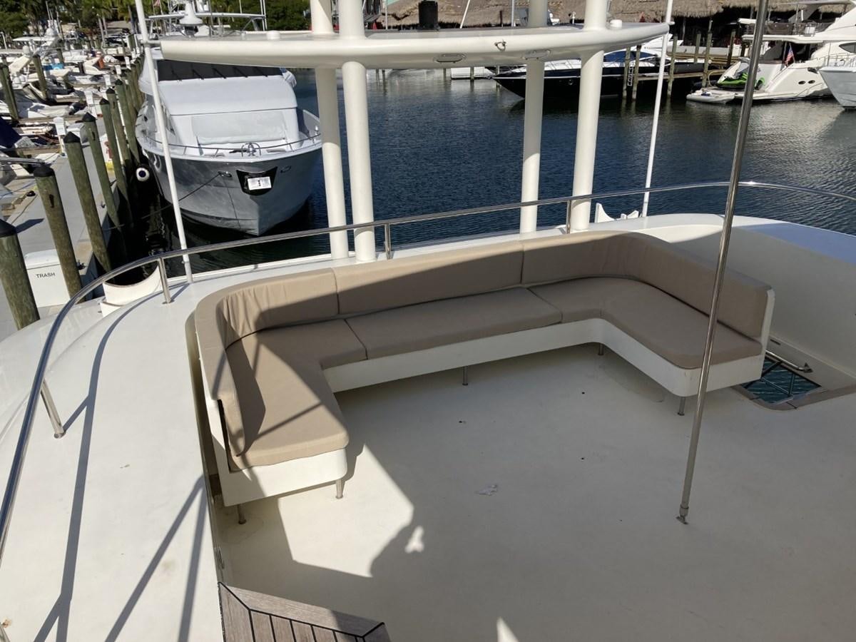 a deck with a chair and a boat on it aboard ANGELE Yacht for Sale
