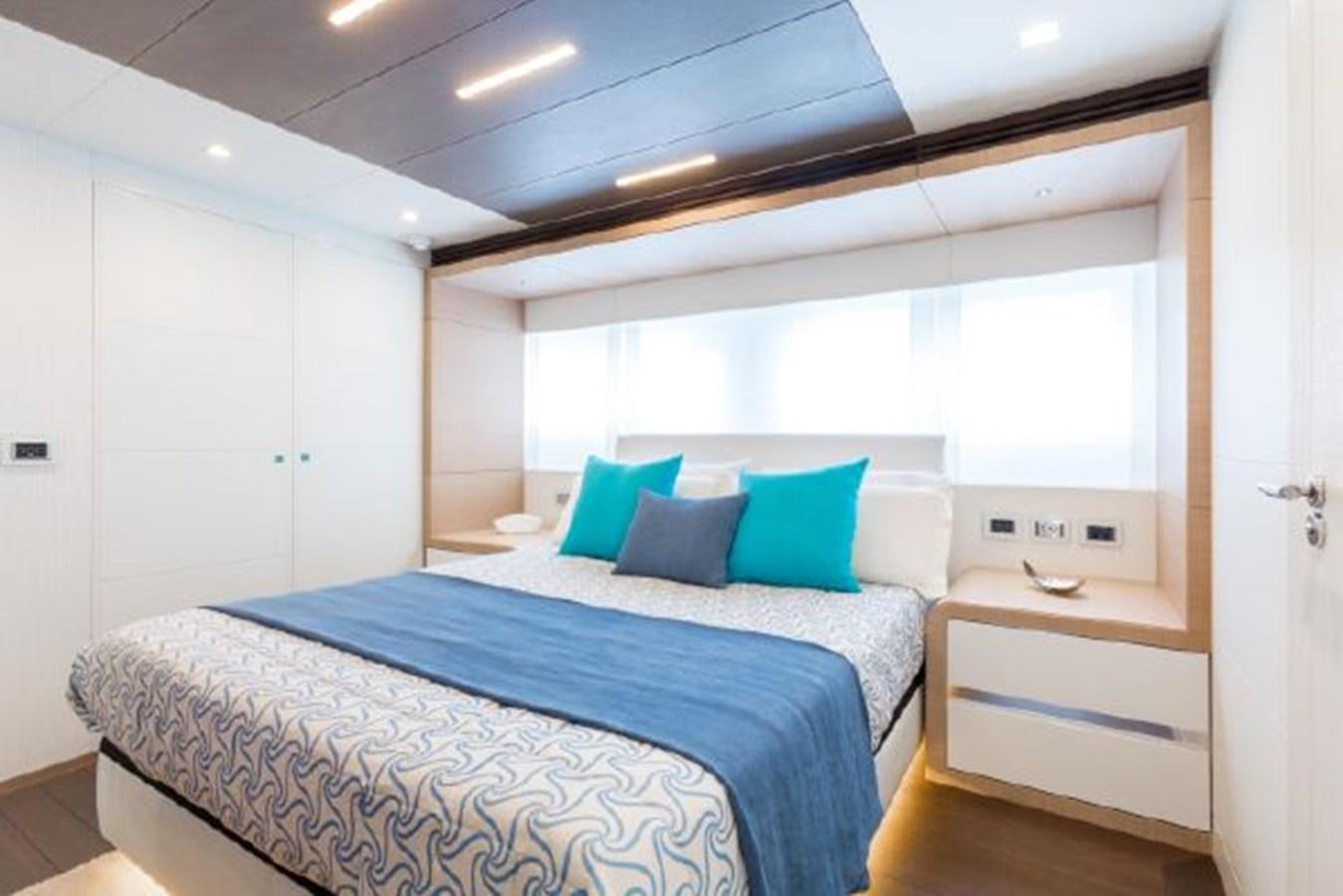 a bed with blue sheets aboard 2021 ASTONDOA 100 CENTURY Yacht for Sale
