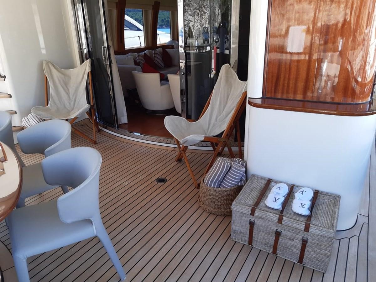 a small room with a bench and chairs aboard CYRUS YACHT 108 Yacht for Sale