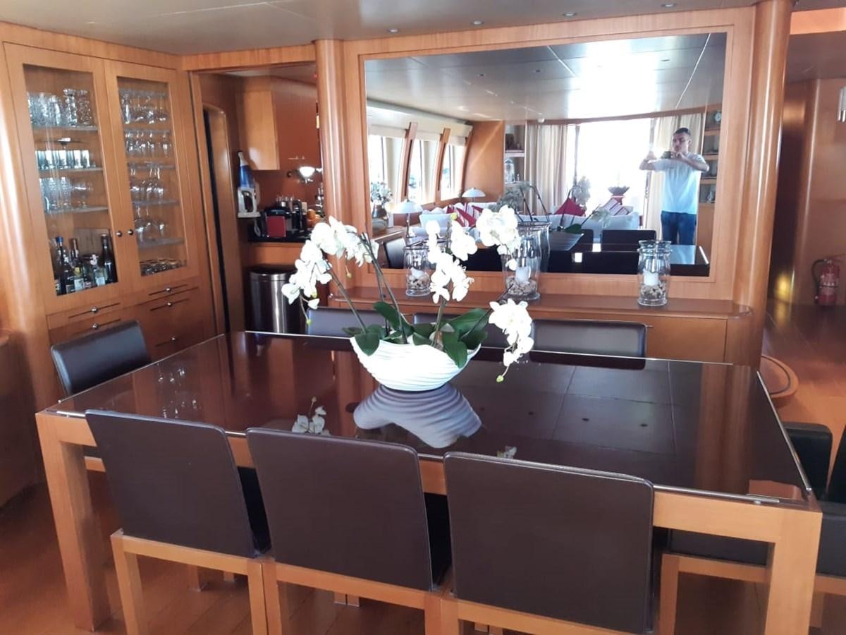 a restaurant with a vase of flowers aboard CYRUS YACHT 108 Yacht for Sale