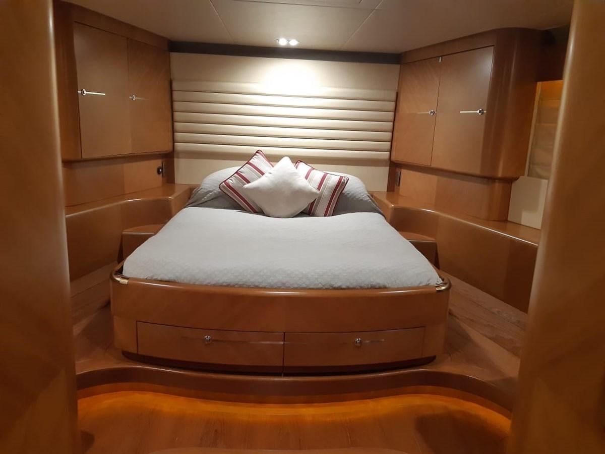 a bed with white pillows aboard CYRUS YACHT 108 Yacht for Sale