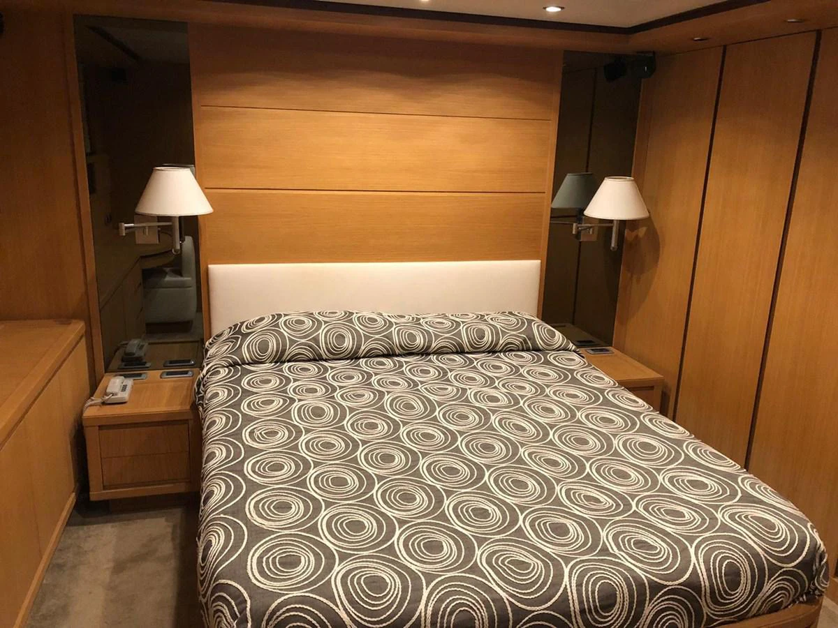 a bed with a lamp on it aboard FIFTH AVENUE Yacht for Sale