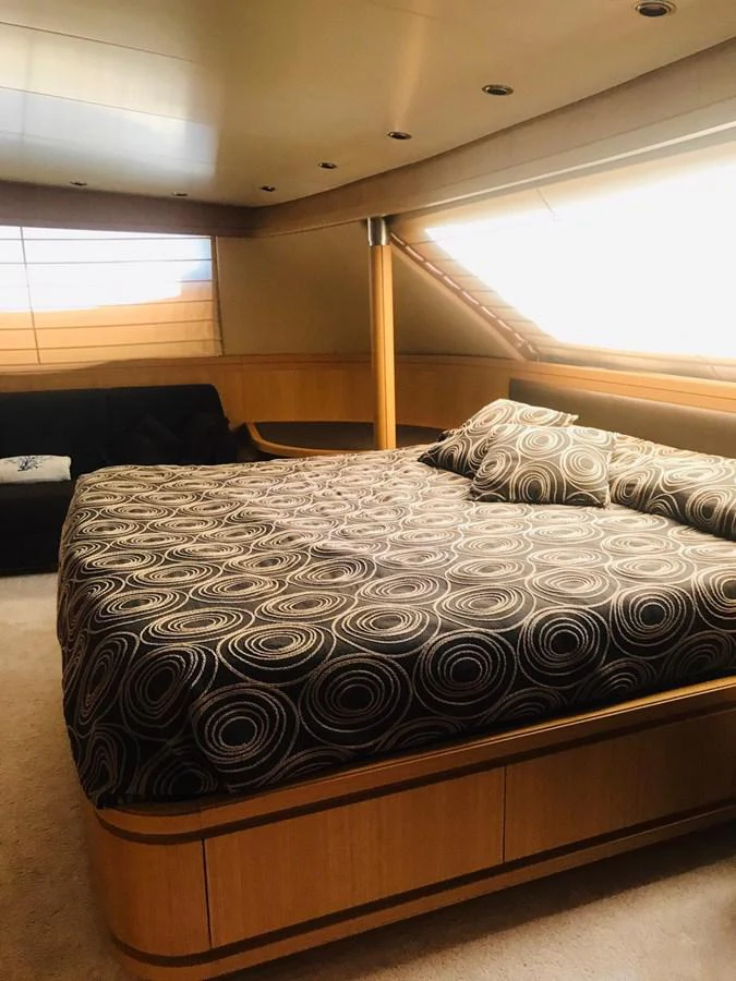 a bed with a black comforter aboard FIFTH AVENUE Yacht for Sale