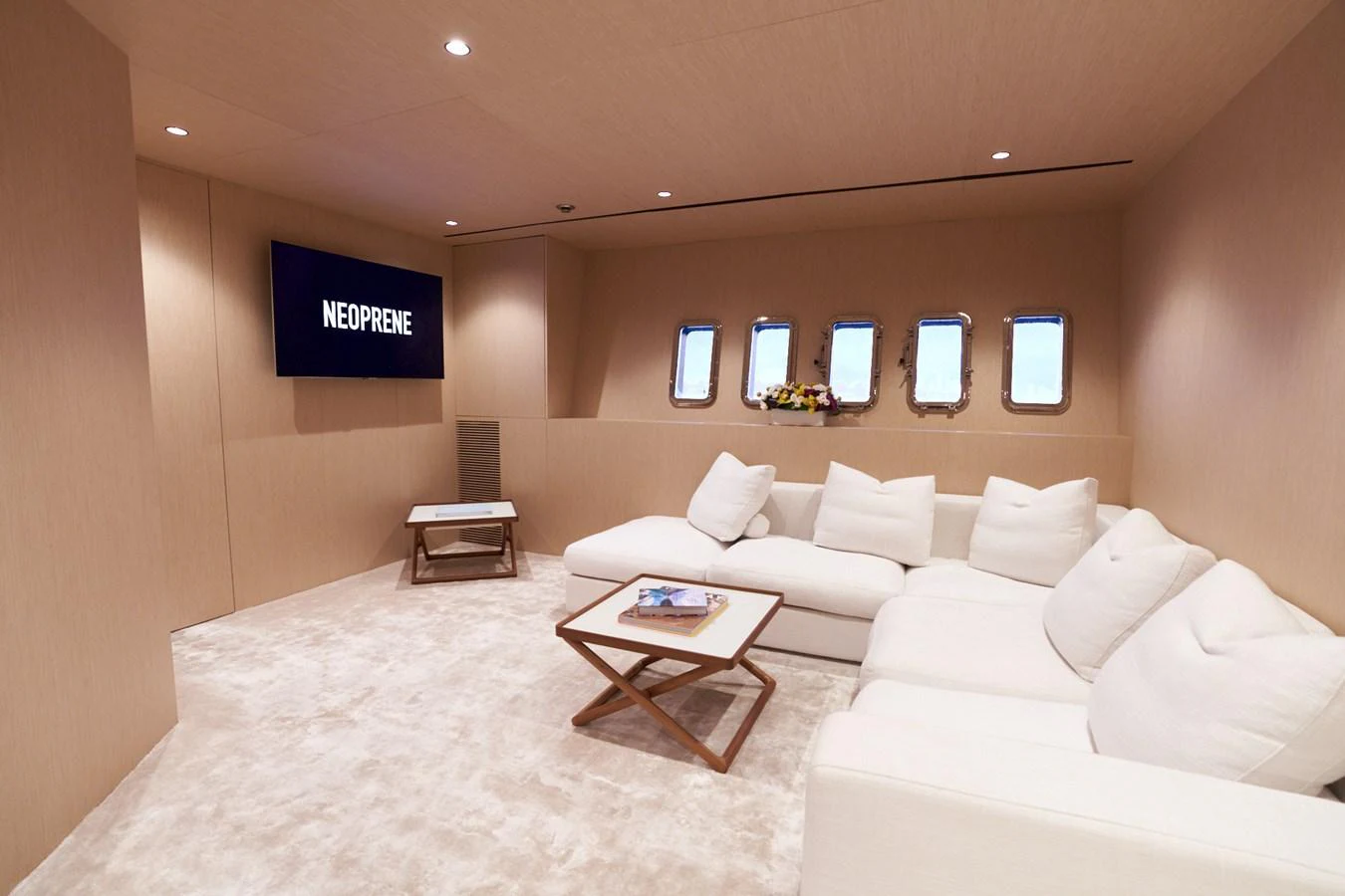 a room with a couch and a television aboard MANGUSTA 108 Yacht for Sale